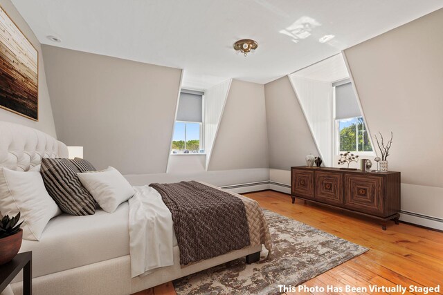 381 W Neck Rd, Lloyd Harbor, NY 11743 - bedroom featuring light wood-style floors, a baseboard radiator, and multiple windows