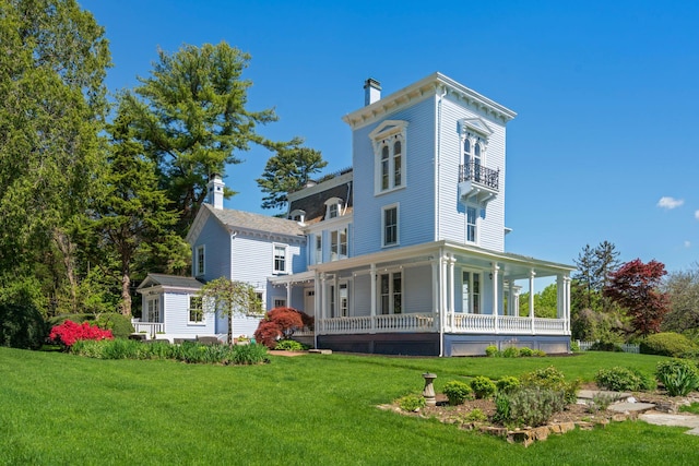 381 W Neck Rd, Lloyd Harbor, NY 11743 - rear view of house with a porch, a balcony, a yard, and a chimney