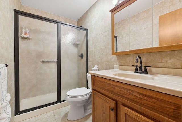 18 Hoppin Ave, Montauk, NY 11954 - full bathroom with vanity, toilet, tile walls, tile patterned floors, and a shower stall