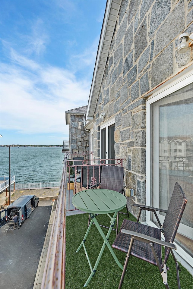 balcony featuring a water view