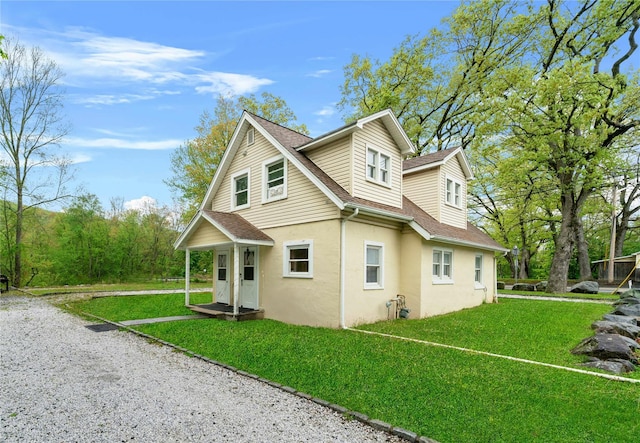 2 Random Rd, Greenwood Lake, NY 10925 - view of side of home featuring stucco siding, a shingled roof, and a lawn