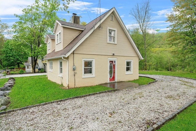 2 Random Rd, Greenwood Lake, NY 10925 - bungalow-style house featuring stucco siding, a chimney, a shingled roof, and a front yard