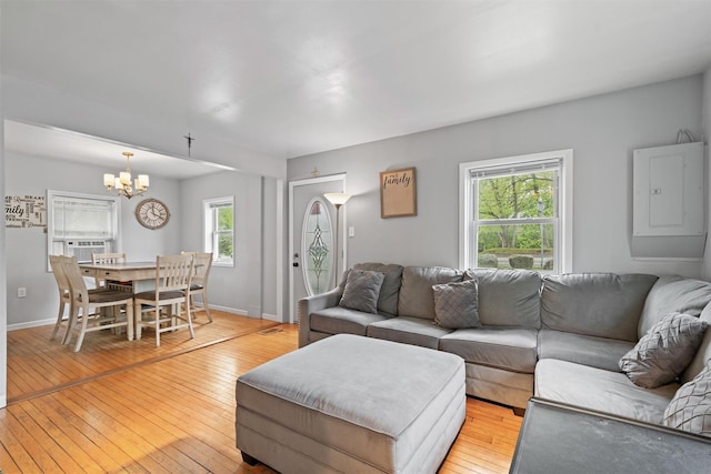 2 Random Rd, Greenwood Lake, NY 10925 - living room with electric panel, a chandelier, light wood finished floors, cooling unit, and baseboards