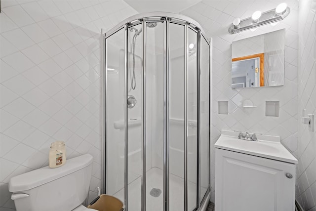2 Random Rd, Greenwood Lake, NY 10925 - full bathroom with tile walls, a stall shower, vanity, and toilet