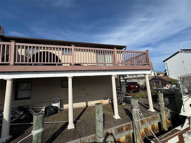 rear view of house featuring a wooden deck