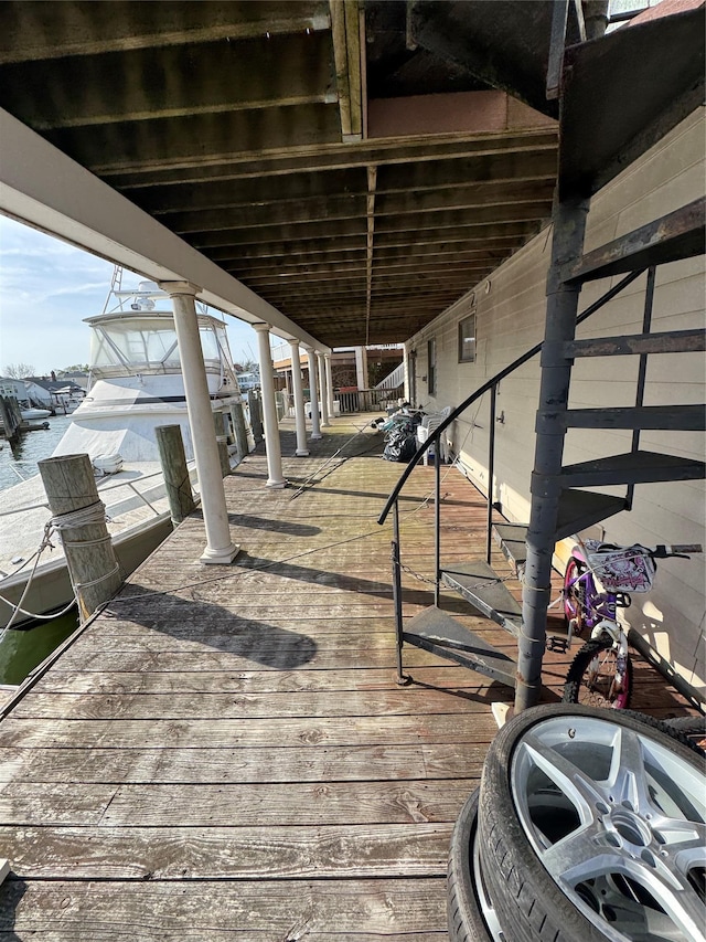 deck featuring a water view and a dock