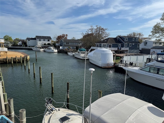 dock area featuring a residential view and a water view