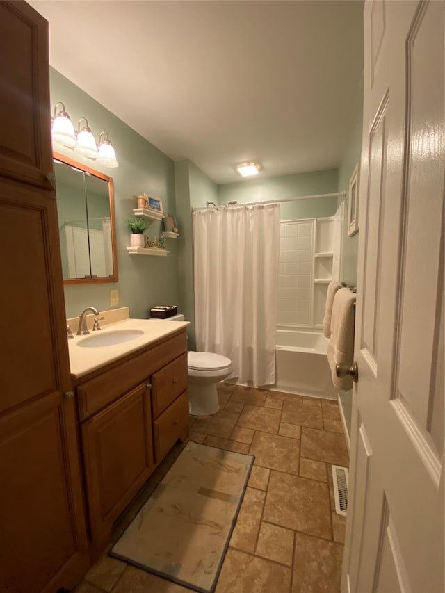 full bathroom featuring visible vents, shower / tub combo, vanity, toilet, and stone tile flooring