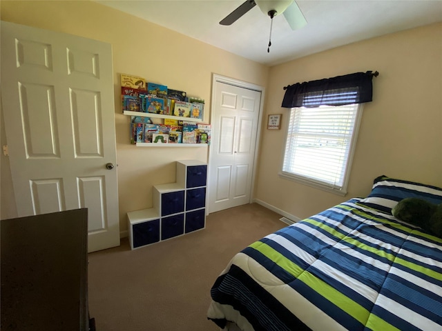 carpeted bedroom with a ceiling fan and baseboards
