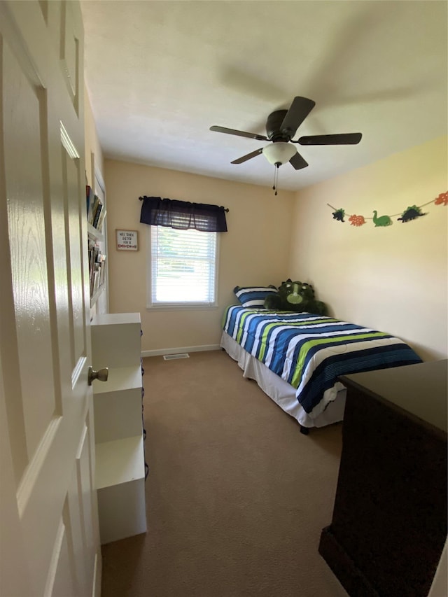 carpeted bedroom with baseboards and ceiling fan