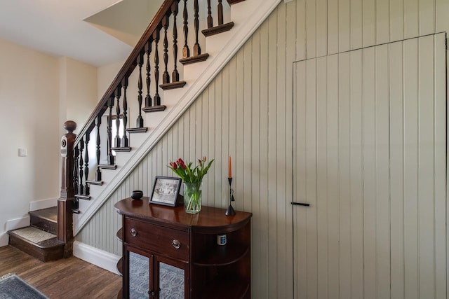stairway with baseboards and wood finished floors