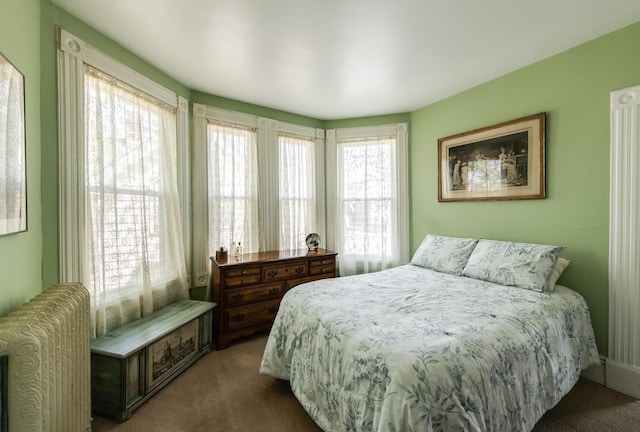 bedroom featuring radiator heating unit and carpet floors