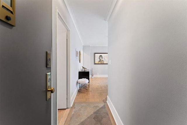 hall featuring baseboards and ornamental molding