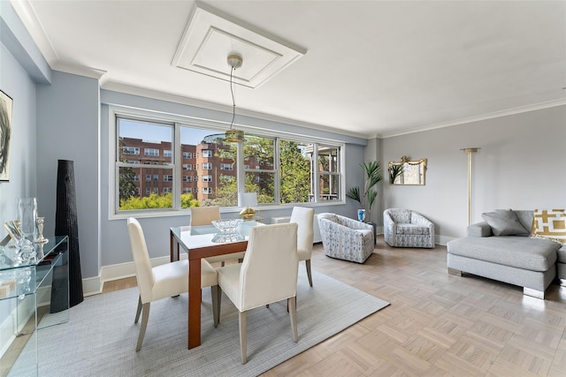 dining room with crown molding and baseboards