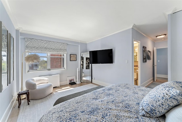 bedroom with ornamental molding and baseboards
