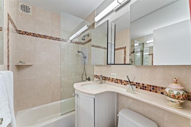 full bath with toilet, visible vents, vanity, bathing tub / shower combination, and tasteful backsplash