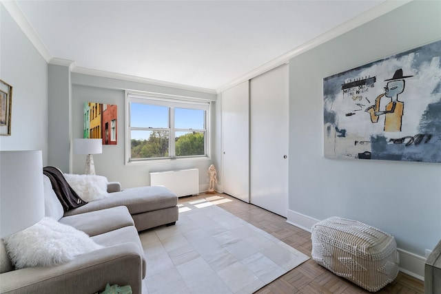 living room with crown molding, baseboards, and radiator heating unit