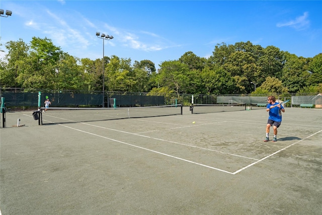 view of sport court with fence