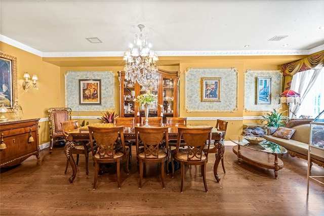 dining area with visible vents, crown molding, wood finished floors, and a notable chandelier