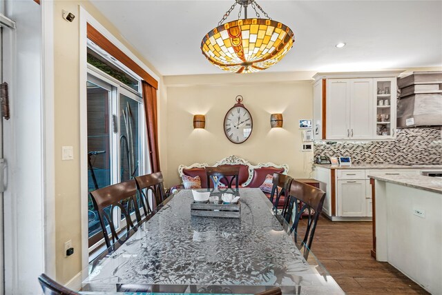 dining space featuring dark wood-style flooring and recessed lighting