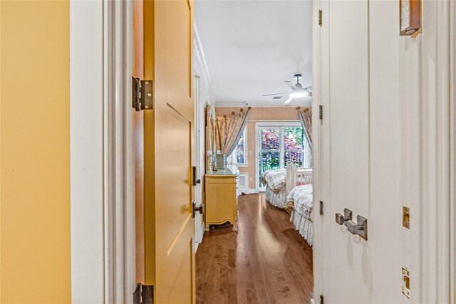 hall with crown molding and wood finished floors