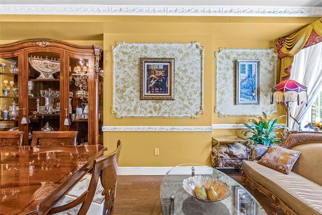 dining room featuring baseboards and wood finished floors