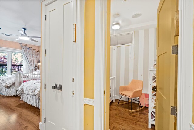 hall with visible vents and wood finished floors