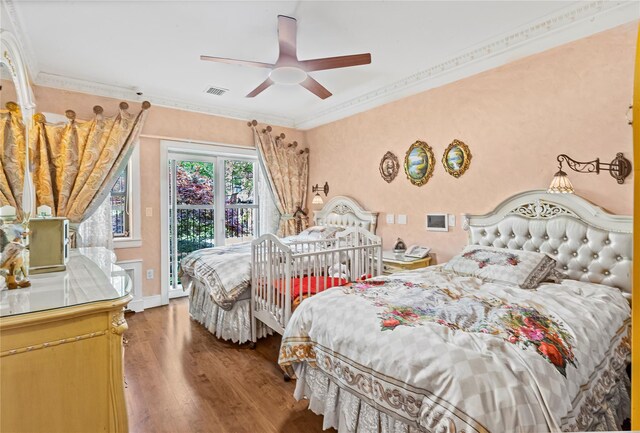 bedroom with ceiling fan, access to exterior, wood finished floors, visible vents, and ornamental molding