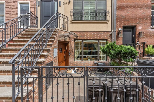 doorway to property featuring brick siding