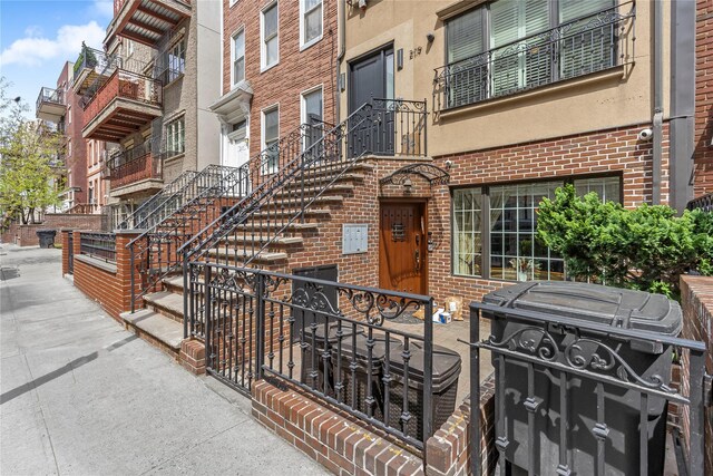 entrance to property featuring brick siding