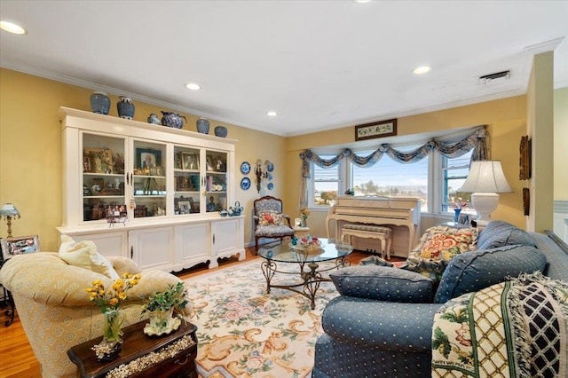 living area featuring recessed lighting, ornamental molding, and wood finished floors