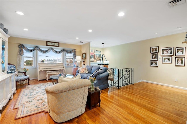 living room with recessed lighting, baseboards, light wood finished floors, and visible vents