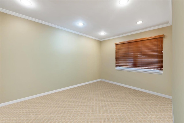 carpeted empty room featuring crown molding, baseboards, and recessed lighting