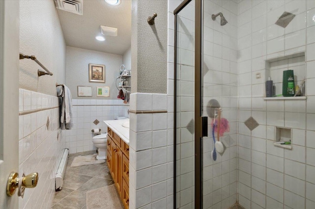 bathroom featuring visible vents, baseboard heating, a stall shower, vanity, and toilet