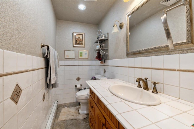 bathroom featuring visible vents, vanity, toilet, recessed lighting, and a wainscoted wall