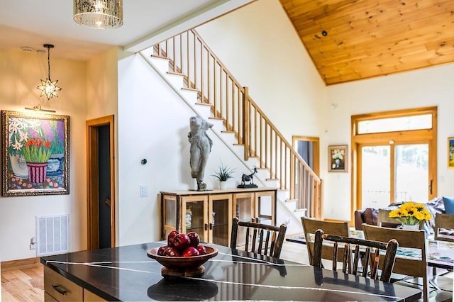 43 Bee Tree Ln, Accord, NY 12404 - dining area with high vaulted ceiling, stairs, and wood finished floors