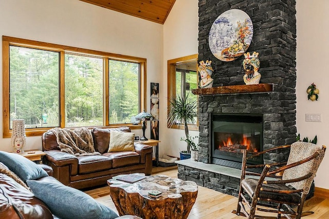 43 Bee Tree Ln, Accord, NY 12404 - living area with vaulted ceiling, a stone fireplace, wood finished floors, and baseboards