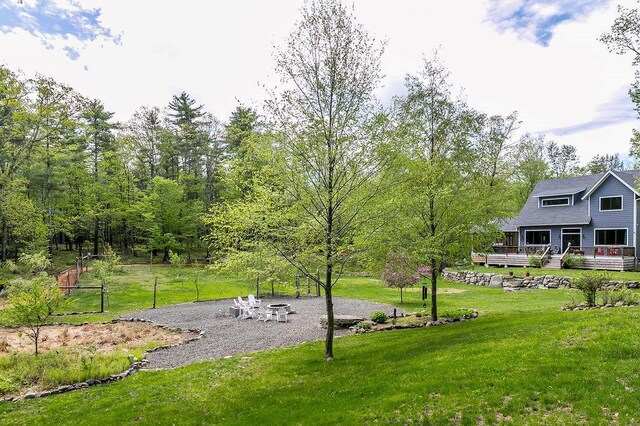 43 Bee Tree Ln, Accord, NY 12404 - view of green lawn featuring a wooden deck and a fire pit