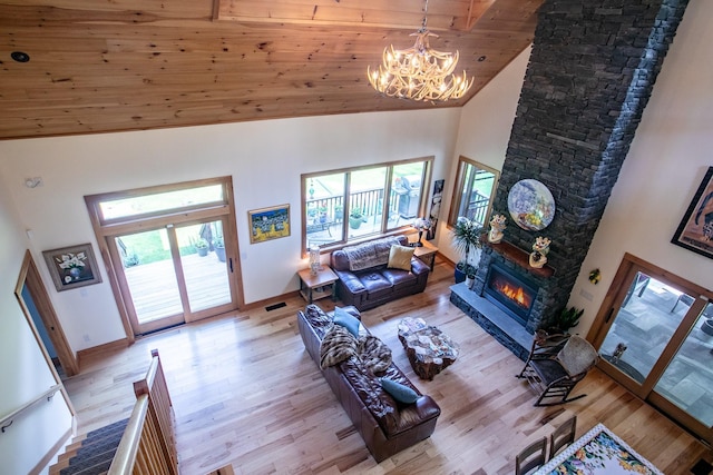 43 Bee Tree Ln, Accord, NY 12404 - living room with high vaulted ceiling, a chandelier, light wood-style flooring, and a fireplace