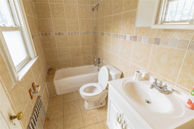 bathroom featuring radiator, tub / shower combination, toilet, tile walls, and tile patterned floors