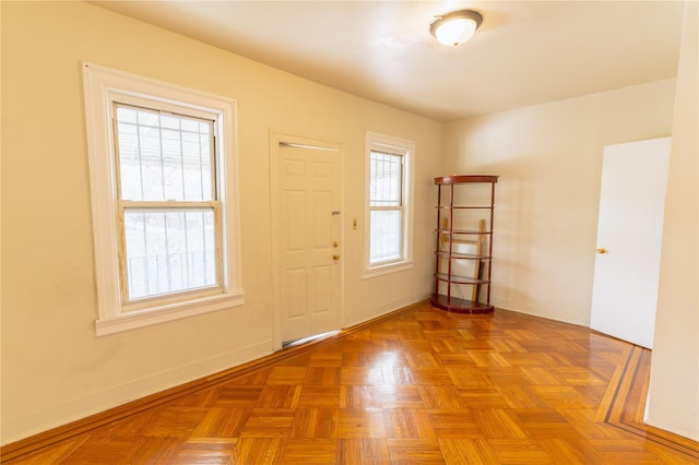 entrance foyer with baseboards and plenty of natural light