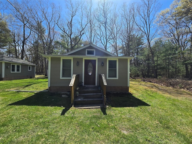 bungalow-style home featuring a front yard and entry steps