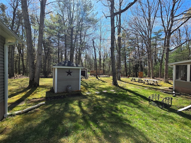 view of yard with an outbuilding and a shed