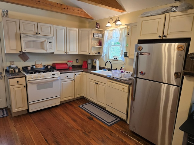 kitchen with dark countertops, white appliances, a sink, dark wood-type flooring, and lofted ceiling with beams