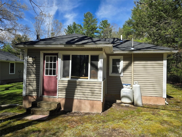 back of house featuring a yard and entry steps