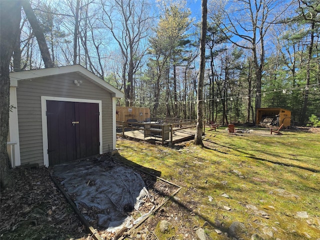 view of yard with a storage unit, an outdoor structure, and fence
