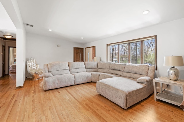 living room featuring light wood-style floors, recessed lighting, and visible vents