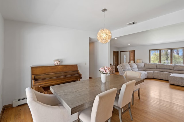 dining area with a notable chandelier, a baseboard radiator, recessed lighting, light wood-type flooring, and visible vents