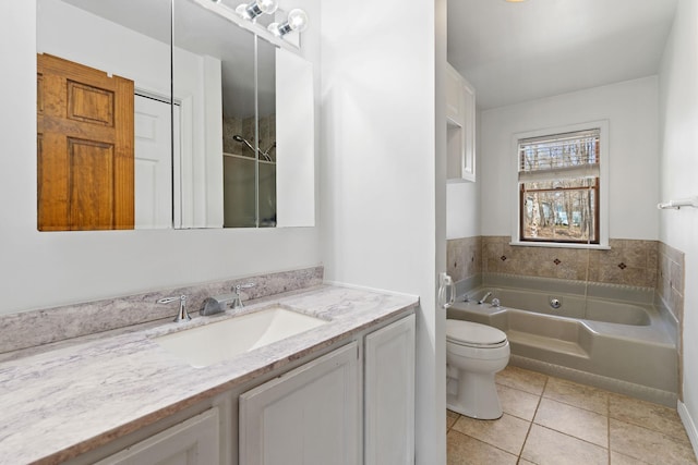 bathroom with vanity, a bath, tile patterned floors, and toilet