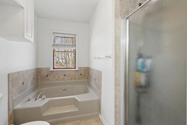 bathroom with a stall shower and a bath